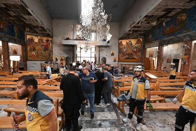 People inspect the damage at the site of a suicide attack at the Mar Elias Greek Orthodox Church in Dweil’a on June 22, 2025. (AFP)