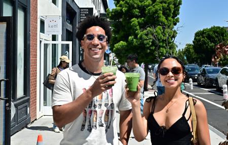 Rohan Cutlip (left) and Alexis Underwood display their iced matcha lattes from Kettl Tea in the Los Feliz neighborhood of Los Angeles, California on May 20, 2025. (AFP)