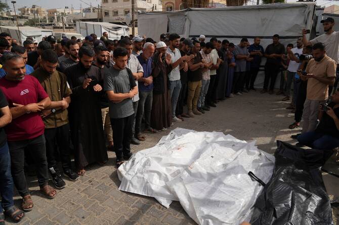 Mourners attend the funeral of members of Al-Aimawi family who were killed in an Israeli bombardment of Al-Zawaideh, at Al-Aqsa Hospital morgue in Deir al-Balah, Gaza Strip. (AP)