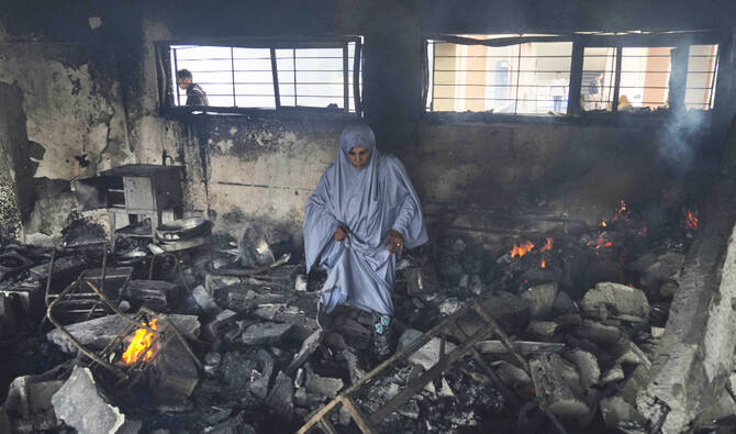 Palestinians inspect the damage after an Israeli army airstrike on Yaffa School, in Gaza City. (AP/File)