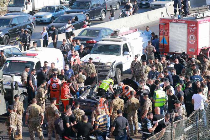 Lebanese emergency responders inspect the debris at the site of a reported Israeli strike on a vehicle in Khaldeh, south of Beirut on July 3, 2025. (AFP)