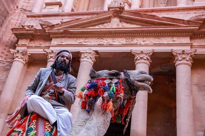 A camel rider poses outside the Treasury in the ruins of the ancient Nabatean city of Petra in southern Jordan. (File/AFP)
