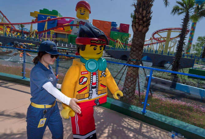 A worker guides a Lego mascot character during the opening of Legoland Shanghai, China’s first Legoland resort, in Shanghai, July 5, 2025. (AP)