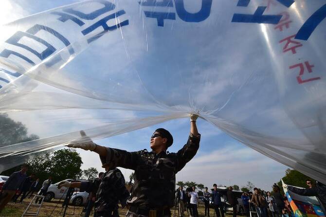 South Korean activists fill gas into a large balloon to launch anti-Pyongyang leaflets into the air at a field near the Demilitarized zone dividing the two Koreas in the border city of Paju on April 29, 2016. (AFP file photo)