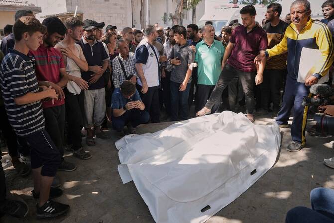 Palestinian mourners gather around the bodies of Dr. Marwan al Sultan, the director of the Indonesian Hospital in the northern Gaza Strip, his wife, his daughter, and his son-in-law, after they were killed in an Israeli airstrike, at Shifa Hospital in Gaza City. (AP)