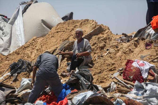 Palestinians inspect the destruction at a makeshift displacement camp following a reported incursion a day earlier by Israeli tanks in the area in Khan Younis in the southern Gaza strip on July 11, 2025. (AFP)