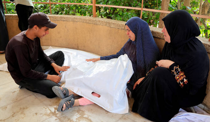 Palestinian woman Ibtehal Abu Shamala holds the body of her daughter Alees, who was killed in morning Israeli strikes on tents sheltering displaced people, according to medics, during her funeral at Nasser Hospital in Khan Younis, southern Gaza Strip, July 14, 2025. (REUTERS)