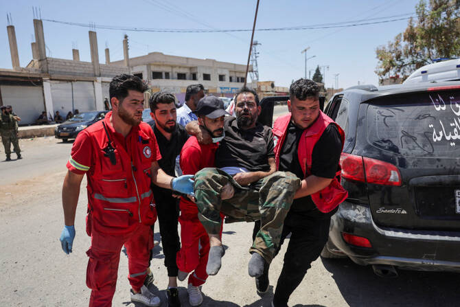 People carry a person injured in recent clashes in Syria's Sweida province following renewed fighting between Bedouin fighters and Druze gunmen on July 18, 2025. (REUTERS)