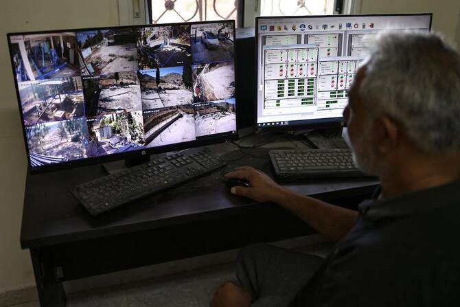 Subhil Olayan, a water pump operator, monitors screens at the pumping station near the Ein Samiyah spring near the village of Kafr Malik, in the Israeli-occupied West Bank, on July 15, 2025. (AFP)