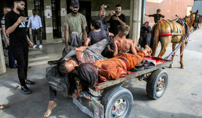 A horse-driven cart carrying injured people and the bodies of dead victims arrives at Nasser Medical Complex in Khan Yunis in the southern Gaza Strip on July 20, 2025. (AFP)