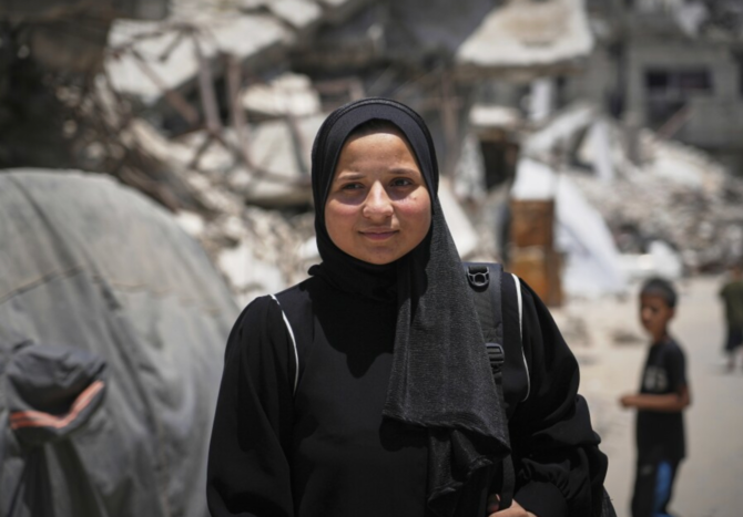 Sarah Qanan studies inside her family’s tent in Khan Younis, Gaza Strip, on June 28, 2025. (AP)