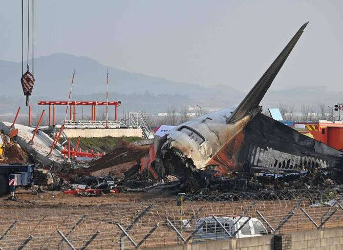 Above, the scene where a Jeju Air Boeing 737-800 series aircraft crashed and burst into flames is seen at Muan International Airport in Muan on Dec. 30, 2024. (AFP file photo)