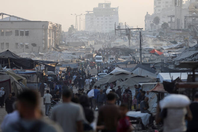 Palestinians gather to collect aid supplies after trucks loaded with aid entered from Israel through central Gaza, in Gaza City July 22, 2025. (Reuters)