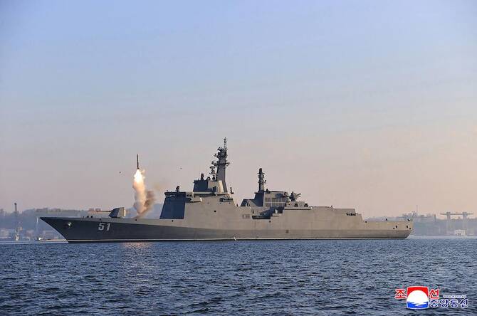 Above, an undated picture shows the test-firing of a weapons system from the deck of North Korea’s latest destroyer, the Choe Hyon, off the coast of an undisclosed location in the country. (KCNA via KNS/AFP)
