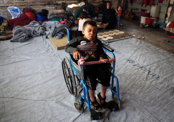 Joud, the nephew of displaced Palestinian Majed al-Bareem, sits in a wheelchair inside an UNRWA school where they shelter, in Khan Younis, in the southern Gaza Strip, on June 4, 2025. (REUTERS)