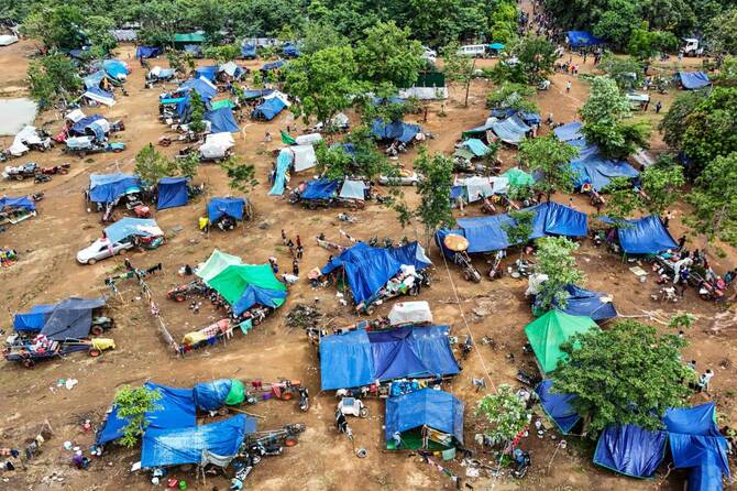 Above, an aerial view of people who fled their homes near the border area between Cambodia and Thailand, taking shelter near a pagoda in Oddar Meanchey province on July 26, 2025. (AFP)