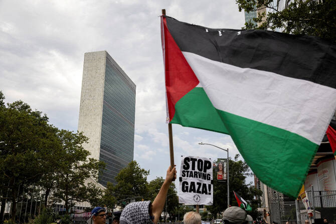 People rally in front of the United Nations headquarters during a