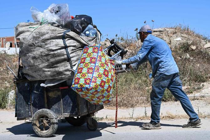 Collecting plastic has become a daily job for thousands of people grappling with poverty in the country. Despite a modest post-Covid rebound, Tunisia's unemployment rate remains stuck at 16%. (AFP)