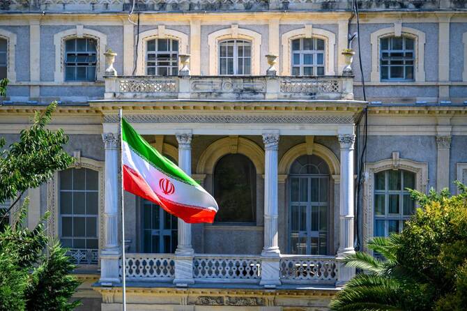 An Iranian flag flutters in front of the Iranian Consulate, where Iranian diplomats meet counterparts from Germany, Britain and France for renewed nuclear talks, amid warnings that the three European powers could trigger 
