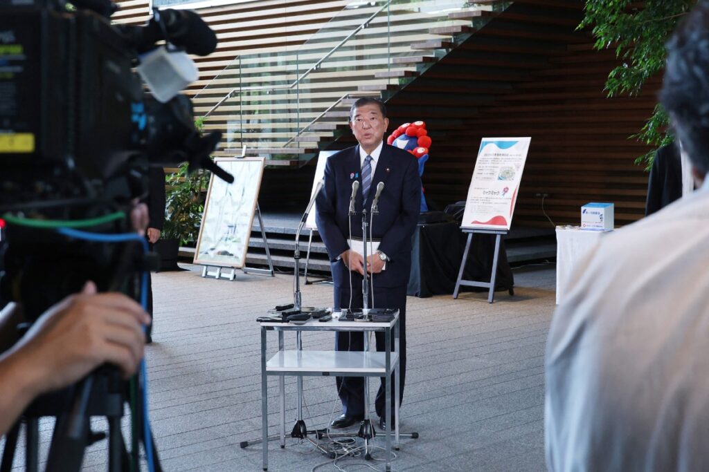 Japan's Prime Minister ISHIBA Shigeru (C) speaks with members of the media following the announcement of a Japan-US tariff agreement, at the prime minister's office in Tokyo on July 23, 2025. (AFP)