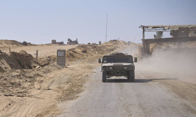 Israeli army vehicles transport a group of soldiers and journalists along the Morag corridor in southern Gaza on June 8, 2025. The Israeli military invited reporters for a tour in the European Hospital in Khan Younis. (AP)