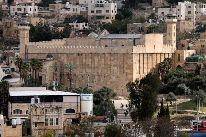 The Ibrahimi Mosque is a microcosm of something far more sinister that is underway across the West Bank (AFP)