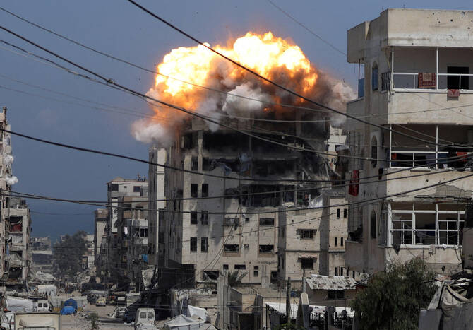 Smoke and flames rise from a residential building hit by an Israeli strike, in Gaza City July 21, 2025. (Reuters)