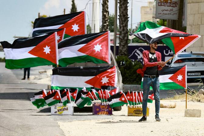 A street vendor displays Jordanian flags for sale in Amman. (File/AFP)
