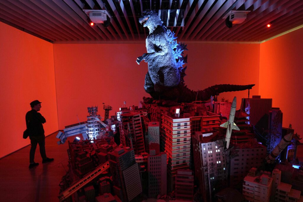 This photo taken on June 26, 2025 shows a man visiting the exhibition commemorating the 70th anniversary of Godzilla's birth, titled GODZILLA THE ART at Tokyo's Mori Arts Center Gallery. (AFP)