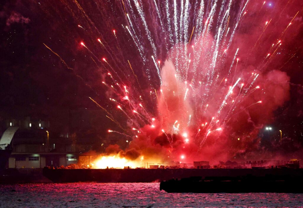 Fireworks are launched from a burning barge during the Minato Mirai Smart Festival, a fireworks festival, in Yokohama, south of Tokyo, Japan August 4, 2025, in this photo taken by Kyodo. Kyodo/via REUTERS