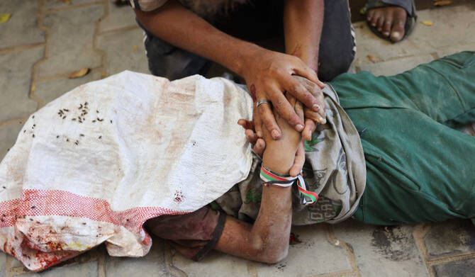 A Palestinian mourns a relative, who was killed while seeking aid in Gaza City on August 5, 2025. (AFP)