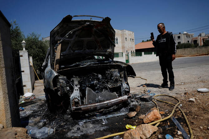 A Palestinian man checks a burnt car after an attack by Israeli settlers in Silwad village near Ramallah, in the Israeli-occupied West Bank, July 31, 2025. (Reuters)