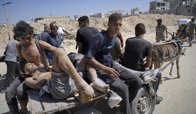 Palestinians are carried after being wounded while trying to reach trucks carrying humanitarian aid en route to Gaza City, in the outskirts of Beit Lahiya, northern Gaza Strip, Friday, Aug. 1, 2025. (AP)