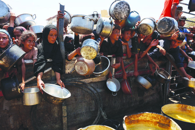 Palestinians receive lentil soup at a food distribution point in Gaza City as malnutrition reaches ‘alarming levels’ in Gaza. (AFP)