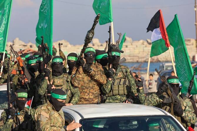 Hamas fighters secure an area before handing over an Israeli-America hostage to a Red Cross team in Gaza City on Feb. 1, 2025. (AFP/File)