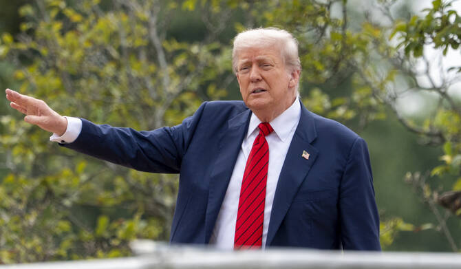 President Donald Trump shouts to reporters as he surveys the grounds from the roof above the Colonnade that goes to the West Wing of the White House, Tuesday, Aug. 5, 2025, in Washington. (AP)