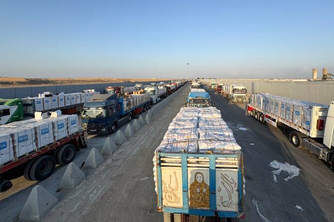 Trucks loaded with humanitarian aid await permission on the Egyptian side of the Rafah crossing with the Gaza Strip, to drive toward the besieged Palestinians territory on August 3, 2025. (File/AFP)