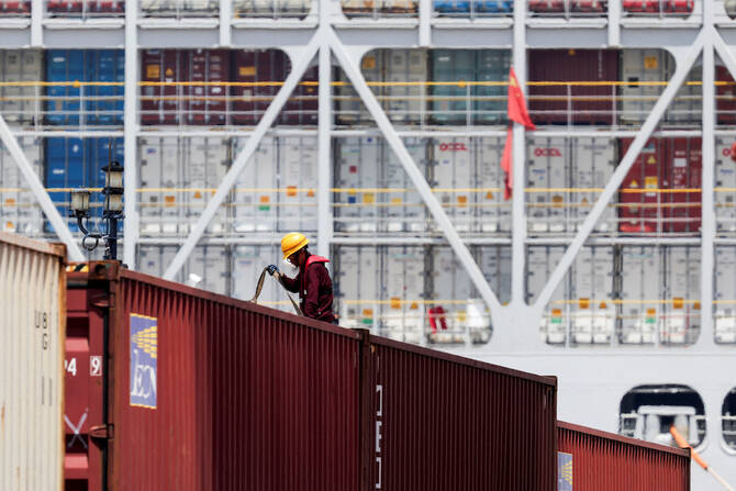 A crew member works on a container ship which is docked at Yangshan Port outside of Shanghai, China. File/ReutersA crew member works on a container ship which is docked at Yangshan Port outside of Shanghai, China. File/Reuters