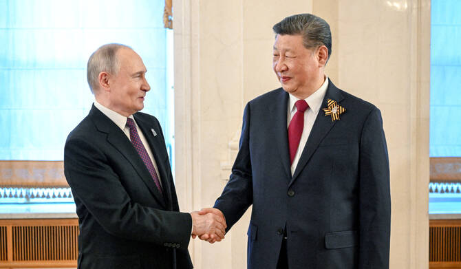 Russian President Vladimir Putin shakes hands with Chinese President Xi Jinping before a festive concert, held on the occasion of the 80th anniversary of the victory over Nazi Germany in World War Two, in Moscow, Russia, May 8, 2025. (REUTERS)