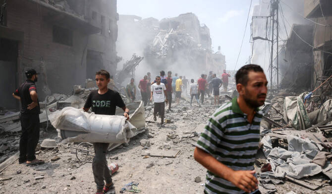 Palestinians check the devastation following an Israeli strike that hit Gaza City's southern al-Zeitoun neighbourhood on August 8, 2025. (AFP)