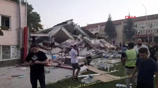 Rescuers are seen pulling a person from the rubble in Balikesir province after a building collapsed following a 6.1-magnitude quake that struck Sindirgi in western Turkey. (Demiroren News Agency/AFP)