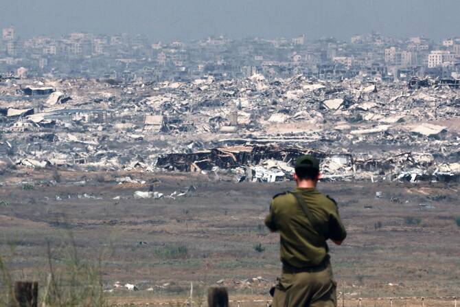 An Israeli army soldier looks at destroyed buildings in the Gaza Strip as troops stand on the border with the Palestinian territory, Aug. 13, 2025. (AFP)