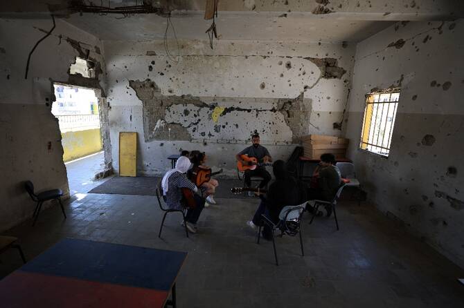 Music instructor Mohammed Abu Mahadi of the Edward Said National Conservatory of Music conducts a lesson at Gaza College in Gaza City. (Reuters)