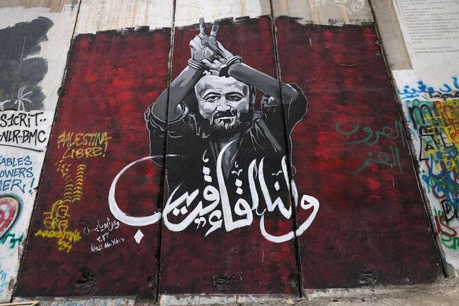 Above, a mural of Marwan Barghouti, a leading member of the Palestinian Fatah party. Barghouti was arrested in 2002 by Israel and sentenced to life in 2004 on murder charges. (AFP)