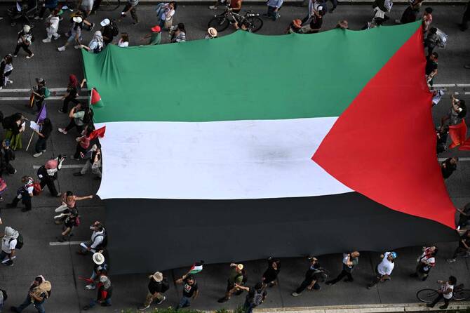 Members of the Global Movement for Palestine wave a giant Palestine flag during a rally against Israel’s actions and ongoing food shortages in the Gaza strip, in Mexico City. (File/AFP)