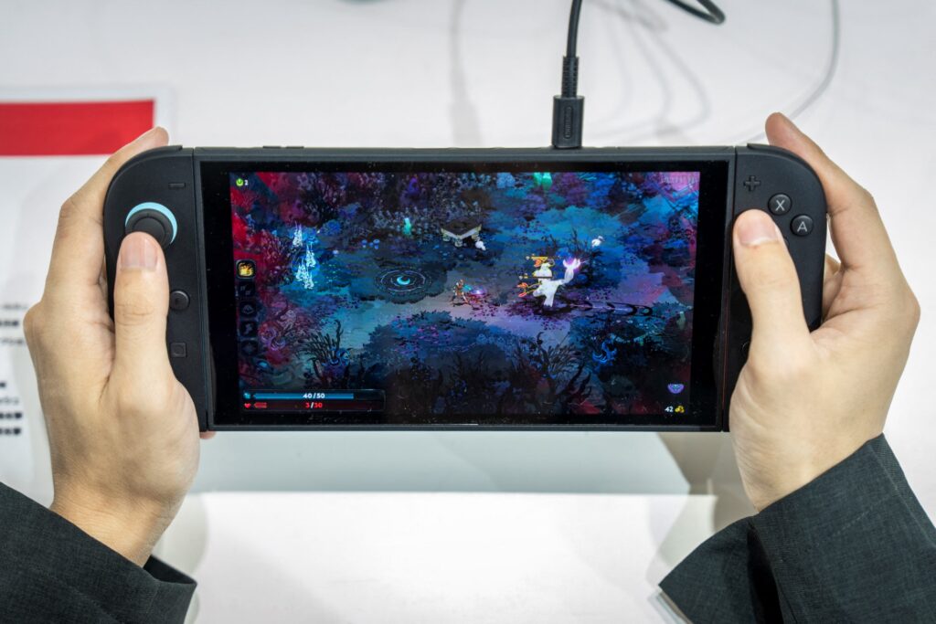 A vistor plays 'Hades 2' an upcoming independent game for Nintendo's Switch 2 during the BitSummit indie gaming expo in Kyoto city, Kyoto prefecture on July 18, 2025. (AFP)
