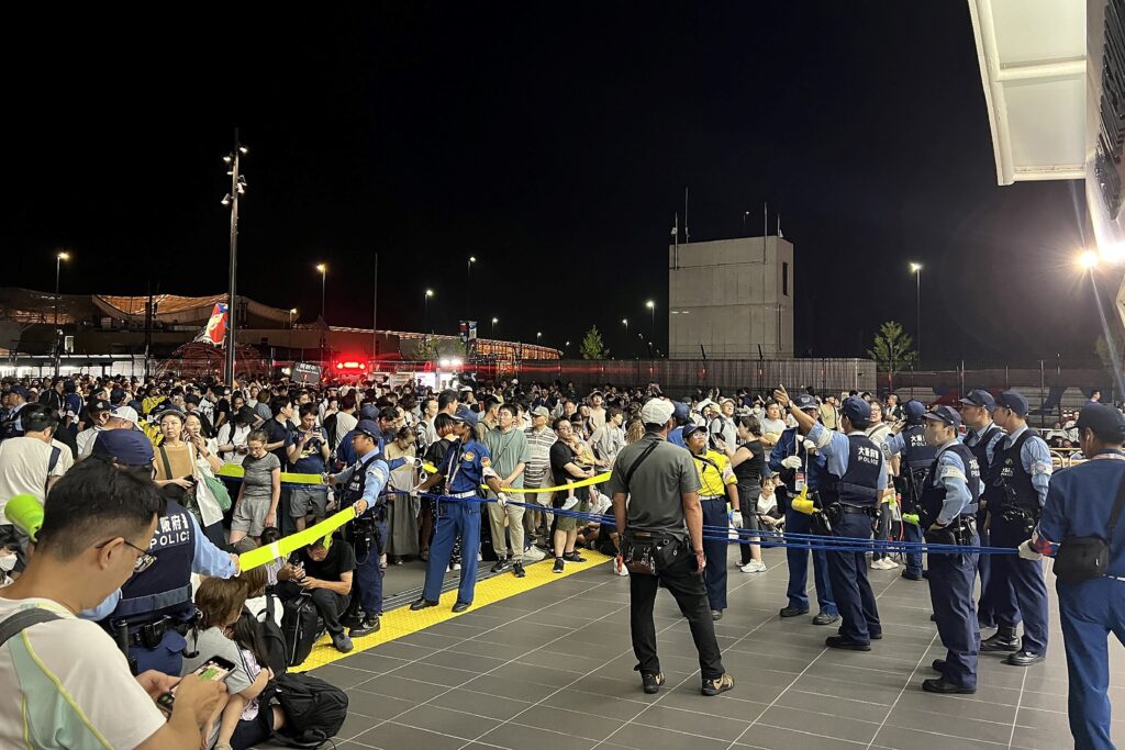 Visitors crowd in front of the entrance to Osaka Metro Yumeshima Station after a power outage abruptly shut down the line, leaving long queues and causing some people to sleep on benches overnight, at the 2025 Osaka Expo in Osaka late on August 13. (AFP)