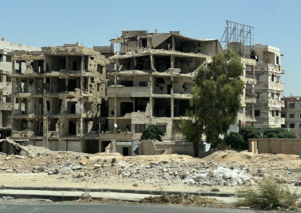 War-destroyed buildings that are housing apartments near Damascus. (ANJ) 
