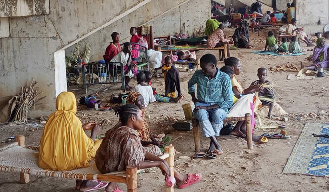 Displaced Sudanese families take shelter in a football stadium in South Kordofan province. (AP)