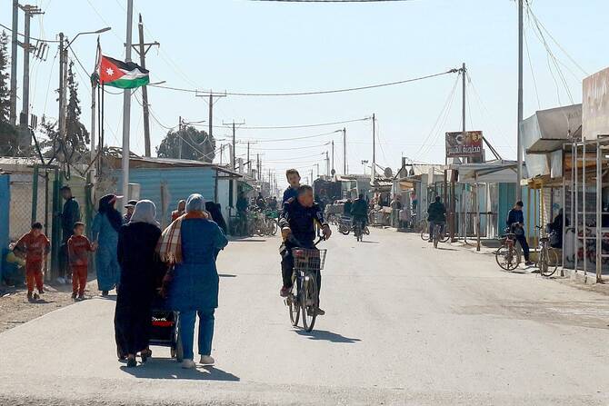 People walk down a street at the Zaatari camp for Syrian refugees, near the Jordanian city of Mafraq, about 80Km north of the capital Amman, Jan. 13, 2025. (AFP)